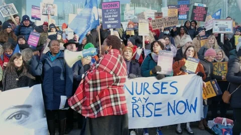 Striking nurses with placards, in protest of government cuts and unfair pay. Stock Footage 231623334