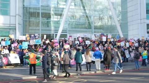 Striking nurses with placards, in protest of government cuts and unfair pay. Stock Footage 231625613