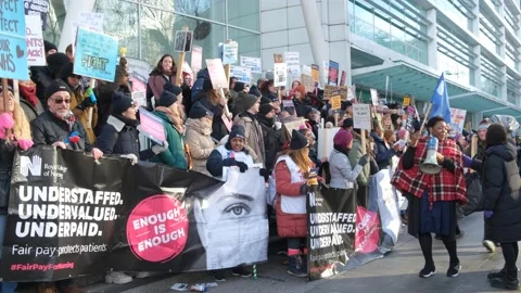 Striking nurses with placards, in protest of government cuts and unfair pay. Stock Footage 231625635
