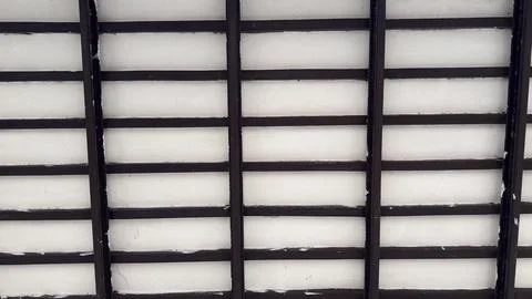 A striking overhead view of a ceiling, showcasing a modern grid pattern forme Stock Photos