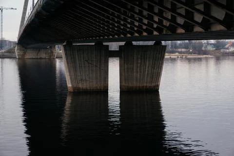 A striking perspective of a cable-stayed bridge over a calm river, showcasing Stock Photos