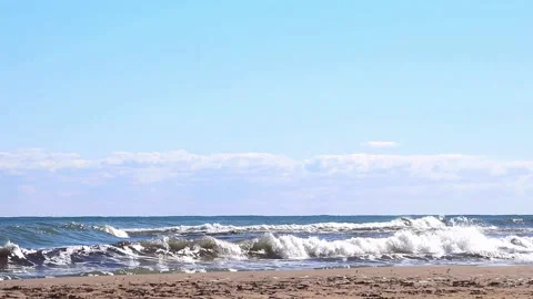 Striking scene of waves breaking on the sand of a Spanish beach Stock Footage 236313743