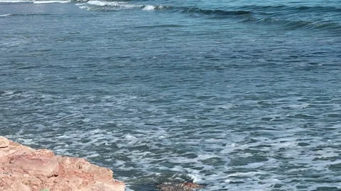 Striking scene of waves breaking on the sand of a Spanish beach Stock Footage 253502309