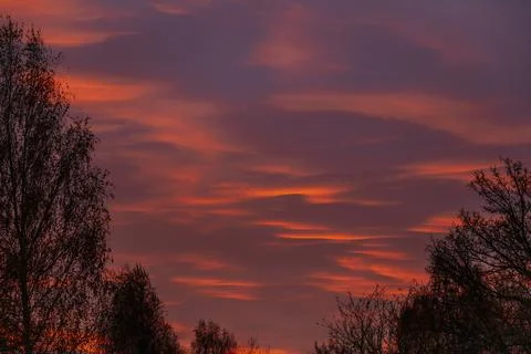 A striking sunset sky glows in deep orange and red hues Stock Photos