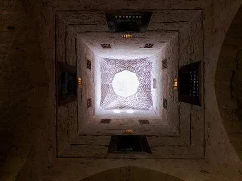 A striking vertical perspective looking directly up inside a historical, square Stock Photos