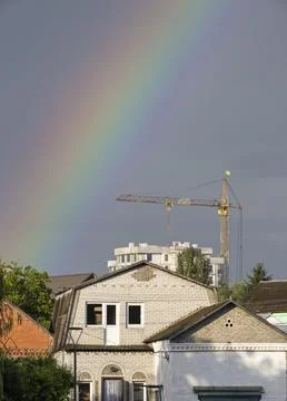 A striking vertical shot of a vibrant, multi-colored rainbow cutting across a Stock Photos