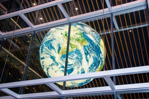 A striking view of a large illuminated globe display inside the Vancouver C.. Stock Photos