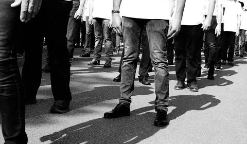 Striking workers marching through the streets of the city in black and whit.. Stock Photos