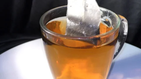 A string and tea bag dipping in the water in cup Stock Footage 111274951