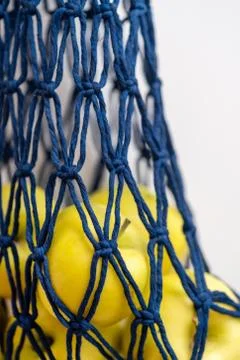 A string bag, a wicker bag made of blue rope with apples, stain plan Stock Photos