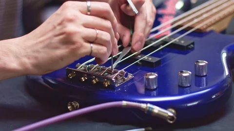 String of bass guitar being stretched for maintenance Video stock 111336468