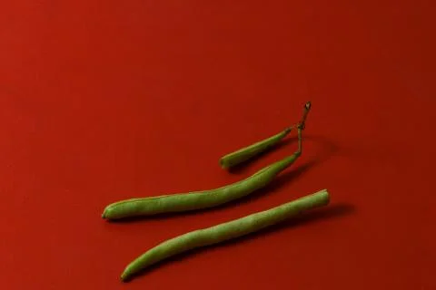 String beans fresh vegetables on isolated red background Stock Photos