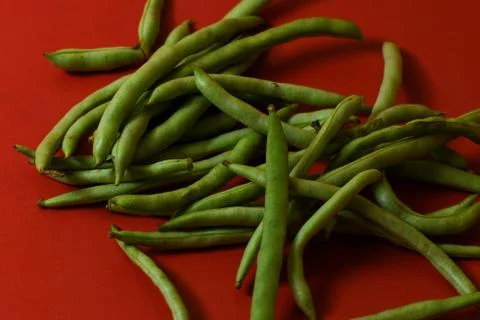 String beans fresh vegetables on isolated red background Stock Photos