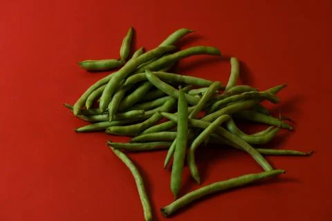 String beans fresh vegetables on isolated red background Stock Photos