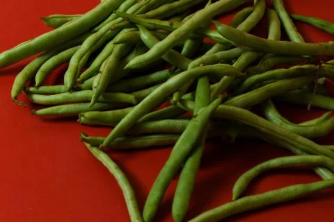 String beans fresh vegetables on isolated red background Stock Photos