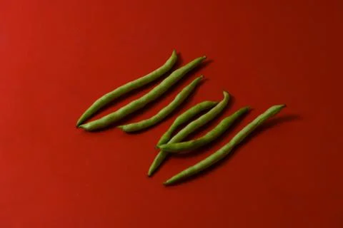 String beans fresh vegetables on isolated red background Stock Photos
