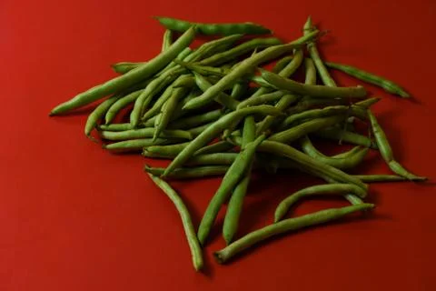String beans fresh vegetables on isolated red background Stock Photos