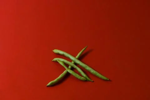 String beans fresh vegetables on isolated red background Stock Photos