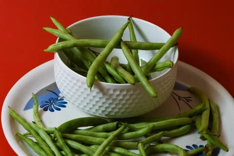 String beans on plate close on isolated red background Stock Photos