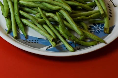 String beans on plate close on isolated red background Stock Photos