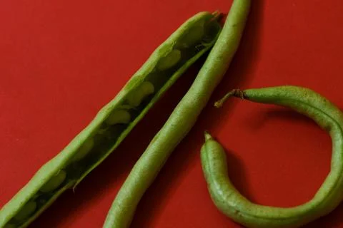 String beans seeds closeup on isolated red background Stock Photos