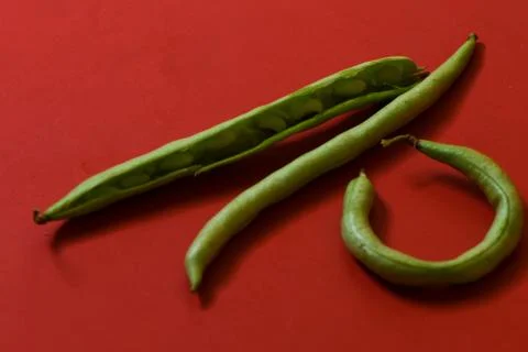 String beans seeds closeup on isolated red background Stock Photos