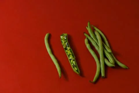String beans seeds closeup on isolated red background Stock Photos