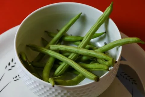 String beans seeds closeup on isolated red background Stock Photos