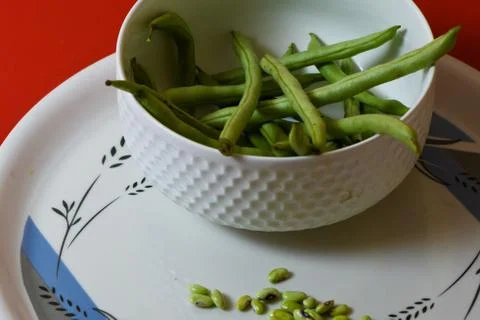 String beans seeds closeup on isolated red background Stock Photos