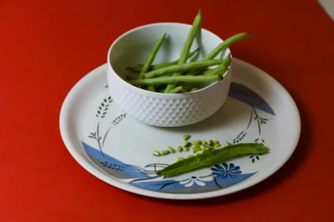 String beans seeds closeup on isolated red background Stock-Fotos