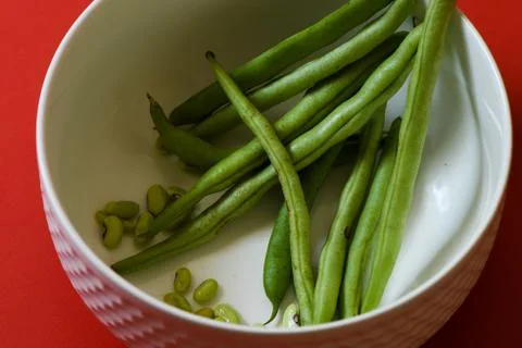 String beans seeds closeup on isolated red background Stock Photos