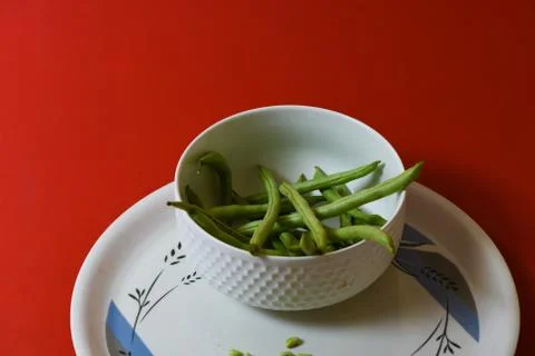 String beans seeds closeup on isolated red background Stock Photos