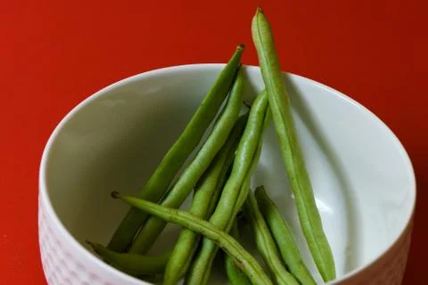 String beans seeds closeup on isolated red background Stock Photos