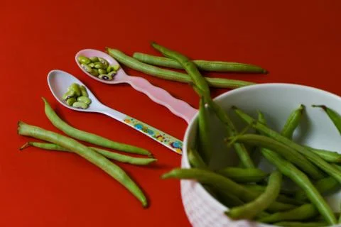 String beans seeds closeup on isolated red background Stock Photos
