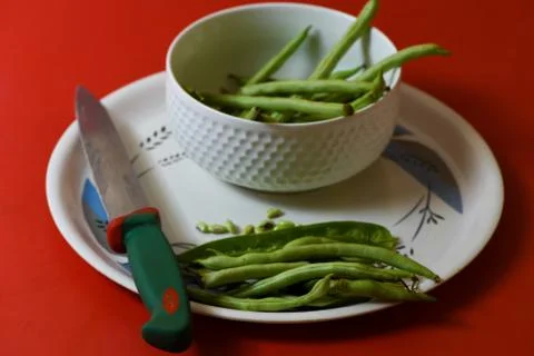 String beans seeds closeup on isolated red background Stock Photos