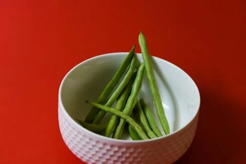 String beans seeds closeup on isolated red background Stock-Fotos