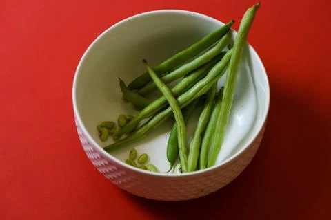 String beans seeds closeup on isolated red background Stock Photos