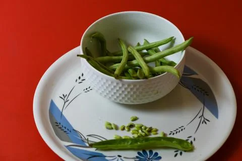 String beans seeds closeup on isolated red background Stock Photos