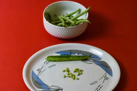 String beans seeds closeup on isolated red background Stock-Fotos