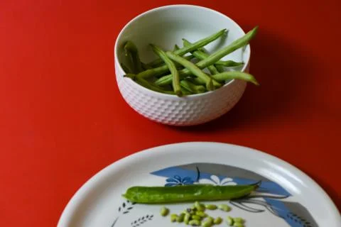String beans seeds closeup on isolated red background Stock Photos