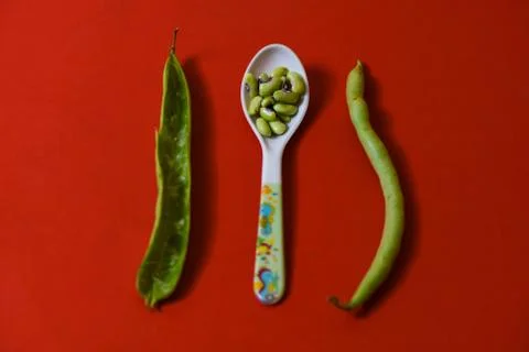 String beans seeds closeup on isolated red background Stock-Fotos