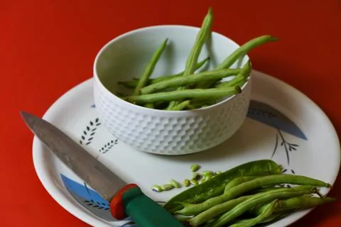String beans seeds closeup on isolated red background Stock Photos