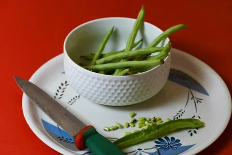 String beans seeds closeup on isolated red background Stock Photos