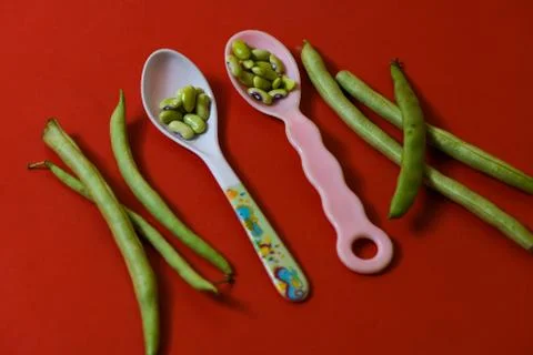 String beans seeds closeup on isolated red background Stock Photos