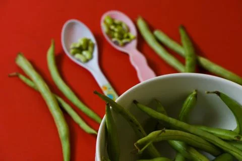 String beans seeds closeup on isolated red background Stock Photos