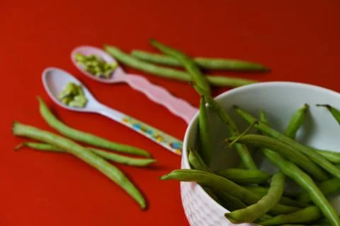 String beans seeds closeup on isolated red background Stock Photos