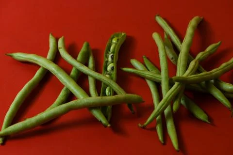 String beans seeds closeup on isolated red background Stock Photos