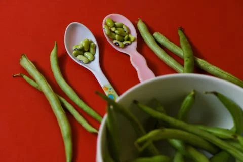 String beans seeds closeup on isolated red background Stock Photos