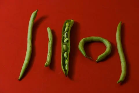 String beans seeds closeup on isolated red background Stock Photos