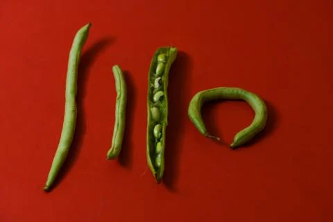 String beans seeds closeup on isolated red background Stock-Fotos